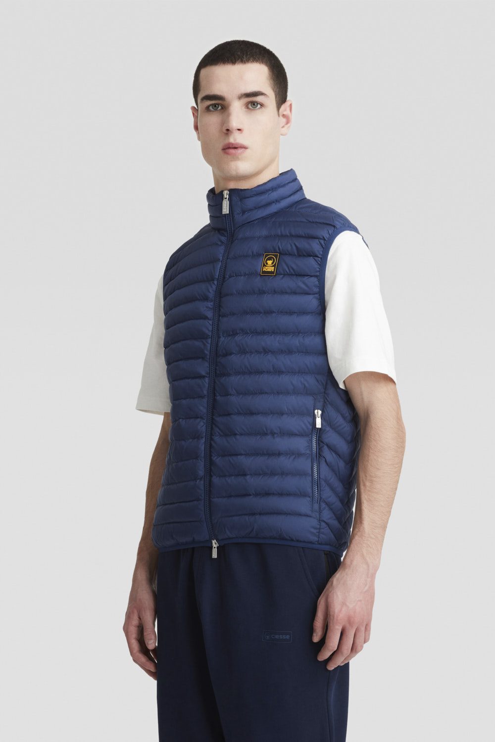 Piumino blu smanicato imbottito in vera piuma